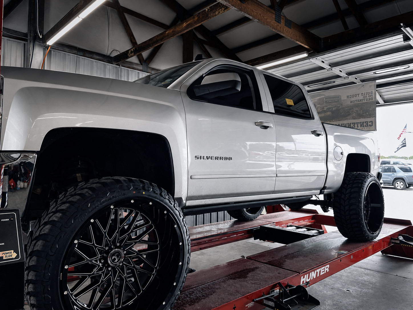 Silverado after lift kit and wheel install, on the alignment rack